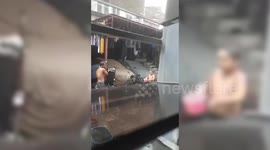Father and son play in the cool summer rains brought by Tyhoon Ambo in the Philippines