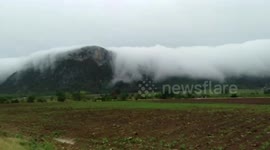 White orographic clouds drift over mountains in Thailand