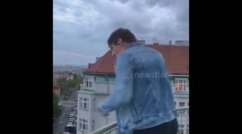 Czech rock band play rooftop gig to lift spirits as country takes steps to relax coronavirus restrictions