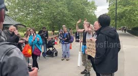 Anti-lockdown protester give out