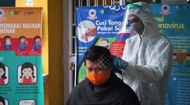 Indonesian health workers given hair cuts in Makassar during COVID-19 pandemic