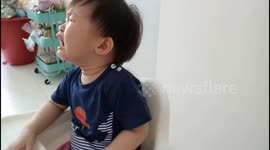 Hilarious toddler stops crying when he is given a big whole cake baked by his mum