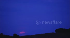 Atmospheric time-lapse of the Flower full super moon rising over Minninglow the Neolithic chambered tomb, Bronze Age bowl barrows & tree circle