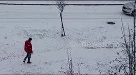 Man walks his dog in the blizzard