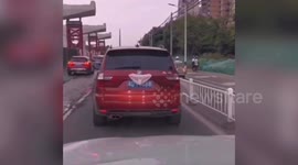 Underwear blocks licence plate on car after winds blow it down from Chinese residential building