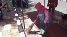 Residents of Indonesia's Padang forced to sweep streets if caught without wearing mask