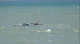 the struggle of two fishermen in the field was floating in the sea with his small boat due to big waves and strong winds