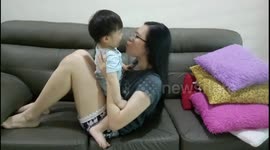 Mom does sit up exercise with toddler during coronavirus lockdown