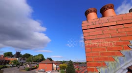 Time lapse of clouds above rooftops in a rural Yorkshire village