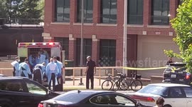 Police and paramedics assist injured person from a shooting in Washington