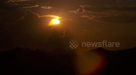 Sun Peaking Behind Clouds