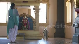 Woman Standing In Front of Hanuman Statue