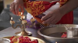 Placing Lit Candles in Tray of Flowers