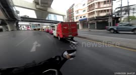 Loose wheel baffles passing drivers after rolling along road in Bangkok