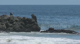 Man On Rock Peninsula