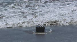 Water Rushing Over Stone in Sand