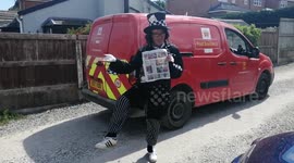 Funny Postman in Fancy Dress Collects Money for Local Hospital