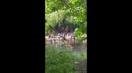 Sunseekers test social distancing by swimming in London's Hackney Marshes in hot weather