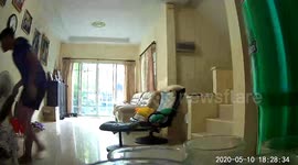 Snake slithers into living room behind Thai pensioner's back before son catches the reptile