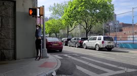 Odd moment man uses crosswalk as pull-up bar in empty Manhattan