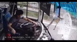 Chinese coach driver pushes away iron bar that crashed through vehicle's windscreen
