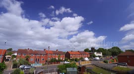 Timelapse of clouds above rooftops in a rural Yorkshire village