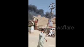 Stunned eyewitnesses in Karachi stop to watch smoke rise from passenger plane crash site