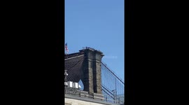 Men with orange bags get to top of Brooklyn bridge to negotiate with suicidal man