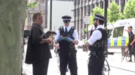 People argue with police over COVID-19 laws outside New Scotland Yard in London