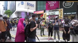 Activist Joshua Wong is applauded by protesters as riot police deploys in Causeway Bay