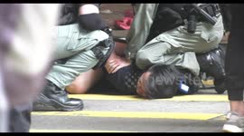 Riot police make an arrest in Hong Kong, after a commotion