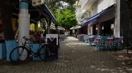 People enjoy drinks and meals in a cafe-bar in Alexandroupoli, Greece