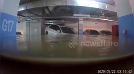 Car accurately floats into parking spot as floodwater submerges underground garage