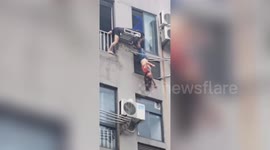 Chinese neighbours rescue woman hanging upside down from seventh-floor laundry rack