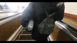 A woman carries her cat in the special bag at undergroung station in St Petersburg, Russia