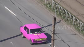 Unusual old Russian car, coloured in pink goes through St Petersburg, Russia