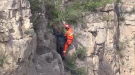 Chinese firemen rescue man trapped on cliff