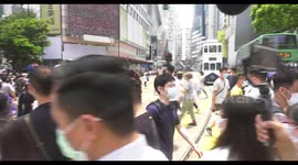 Hong Kong riot police warn chanting crowds during rally against national anthem bill
