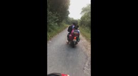 The man carrying six children on a motorbike moving on the road