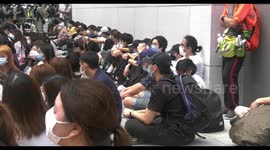 Protesters and bystanders are forced to sit down after being coralled in by riot police in Causeway Bay