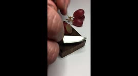 Incredibly tiny knife slices grape with super-satisfying ease