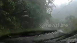 Landslide blocks mountain road during storm in Taiwan