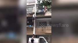 Chinese man climbs three floors barehanded to rescue toddler hanging from window
