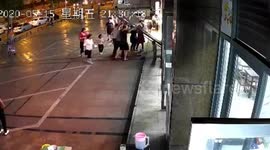 Chinese woman blocks falling glass door to rescue girl