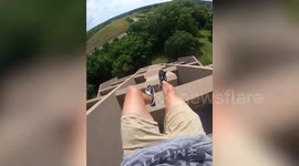Moment daring free runner from Texas films himself sliding down side of high-rise building