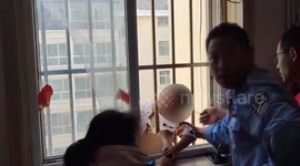 Firefighters break into flat to rescue Chinese boy hanging from fourth window