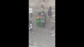 Rioter starts dumpster fire