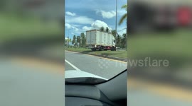 Truck driver takes a shortcut across highway's central island