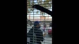 Store Owner Standing Outside Protecting Store from Looters as Cops begin firing gas and flash grenades.