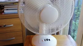 Electric fan being switched on, being taken through three different modes and being switched off again.